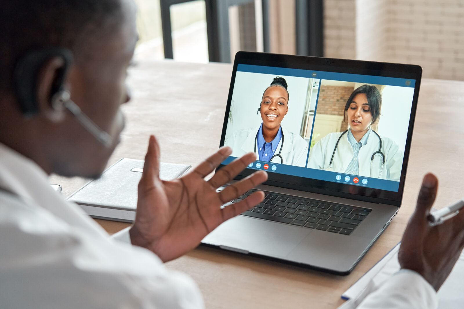 doctor videoconferencing with two femail doctors